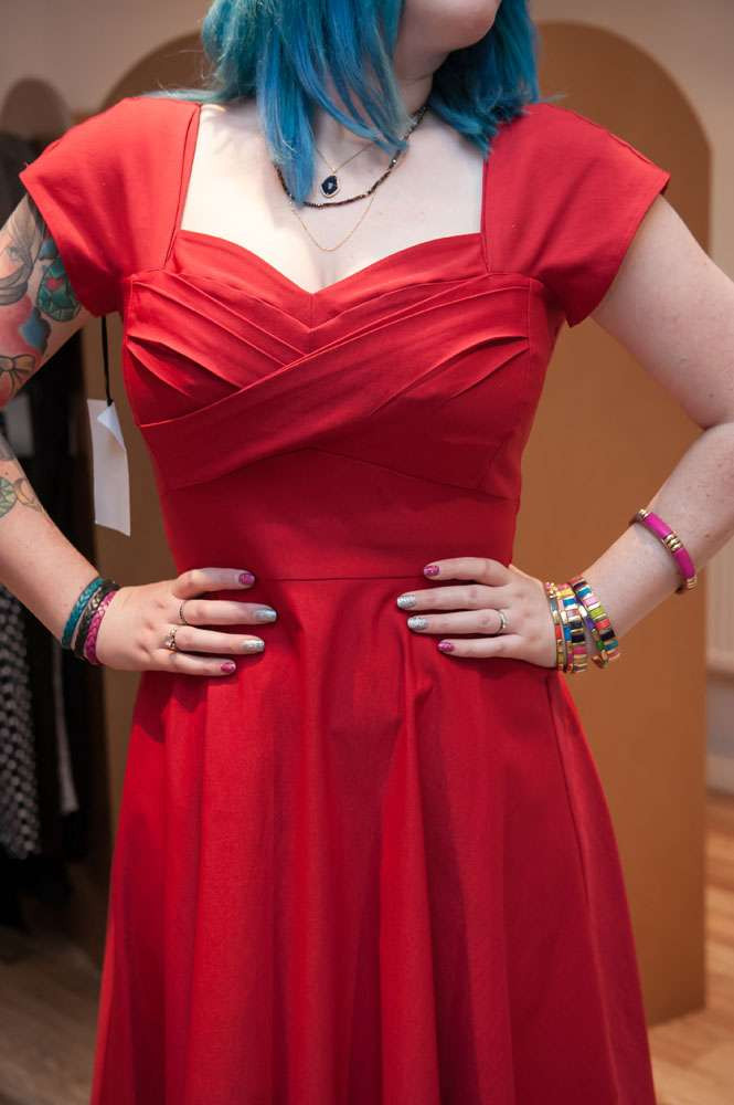 Kat Forsyth in a sophisticated retro dress with sleeves at Revival Retro Boutique