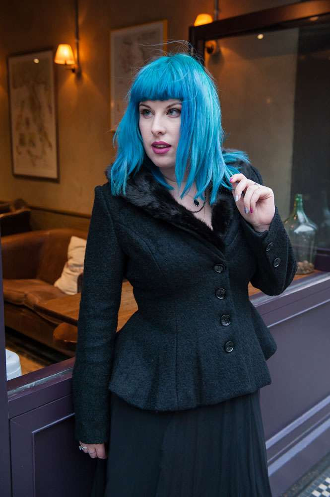 Kat Forsyth wearing a faux fur collared jacket over her retro dress