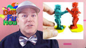 Neil Dandy showcasing a miniature, discount store version of Rock 'Em Sock 'Em Robots, emphasizing the toy's wide range of iterations across different price points.