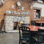 The historic Rock Springs Cafe with a covered wagon in front, showcasing its old west charm.