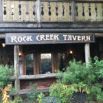 The Rock Creek tavern main sign is easy to spot from the street - while most of the structure except the fireplace is wooden - adding to the vintage feel and esthetic