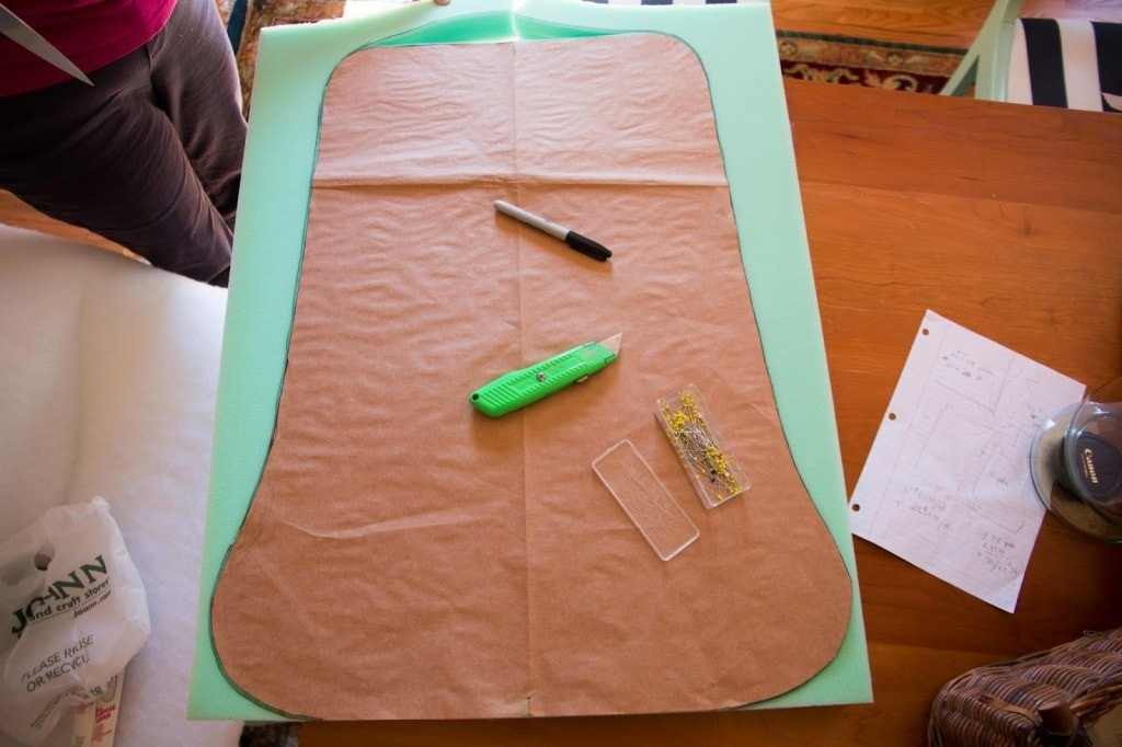 Cutting foam for DIY upholstered rocking chair cushions with a knife, illustrating the foam cutting process