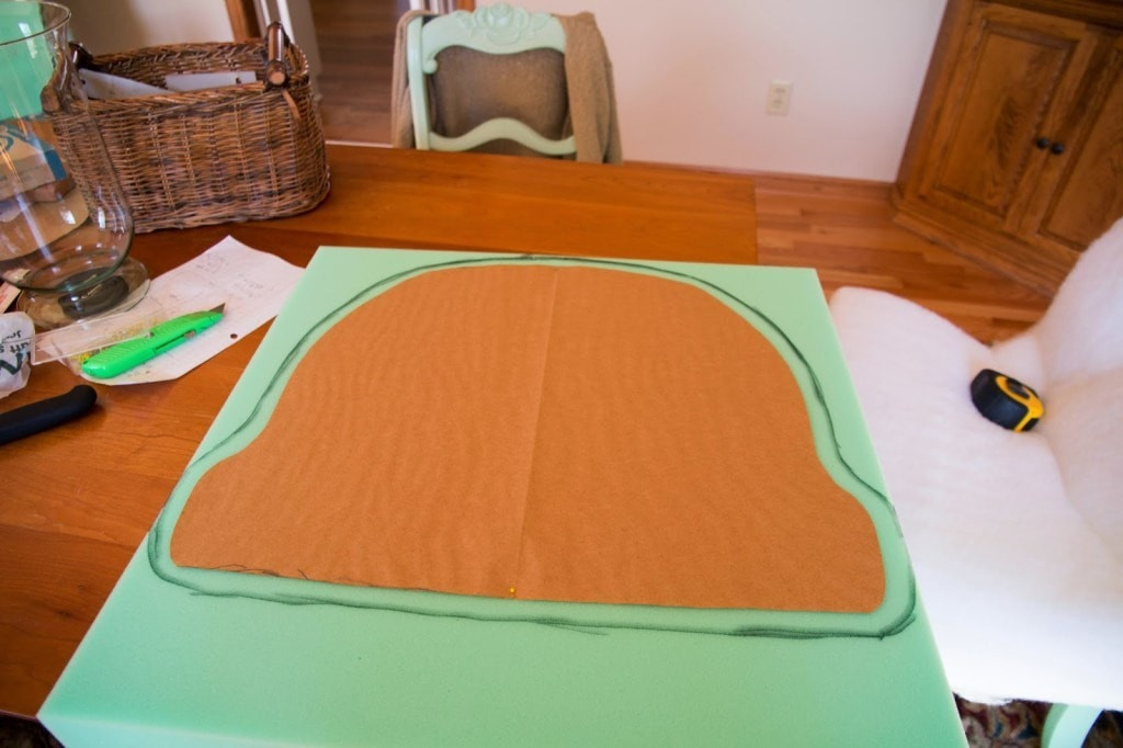 Hands shaping cut foam for a rocking chair cushion, emphasizing the shaping and preparation of foam inserts