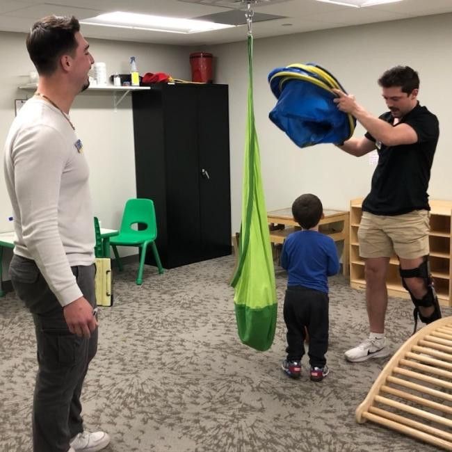 Student clinicians engaging with a client during a speech therapy session at Augustana College