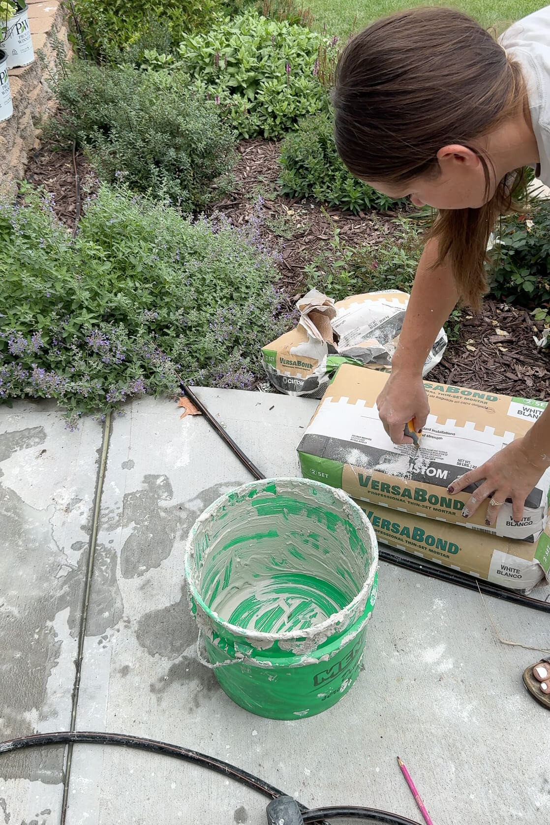 Preparing to mix mortar in a bucket for the rock siding project.