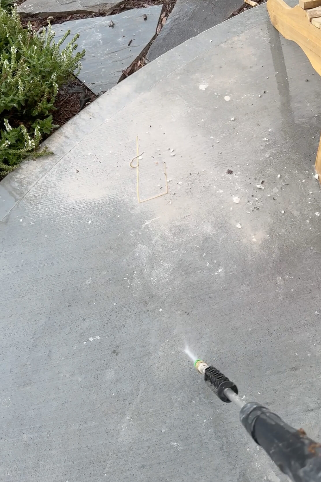 Using a pressure washer to clean up excess mortar and keep the work area tidy.