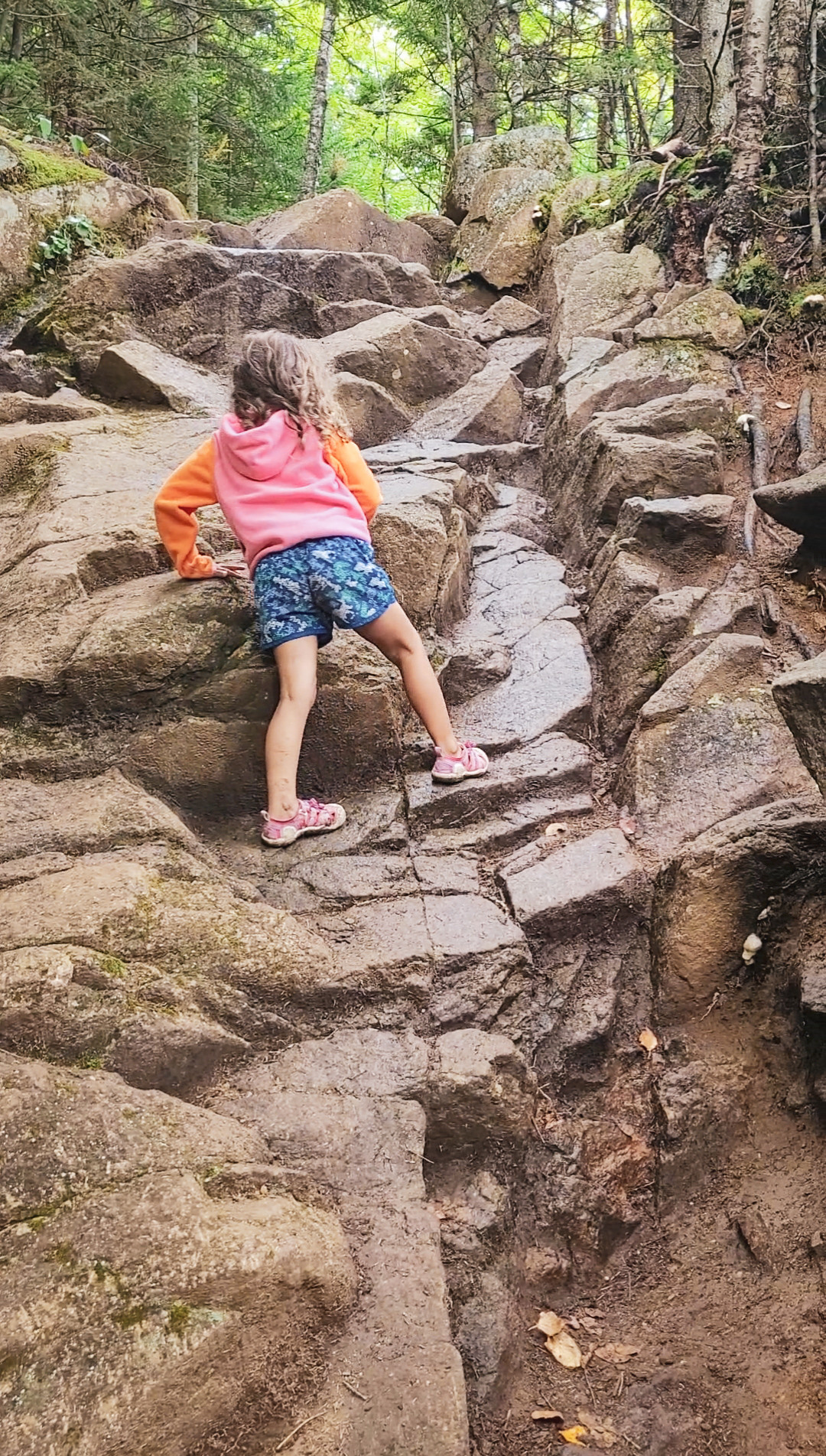 Hikers encounter a rocky scramble section on the Balanced Rocks trail, requiring careful footing.