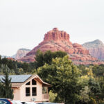 Panoramic view from Hilton Sedona Resort at Bell Rock parking area showcasing red rock formations