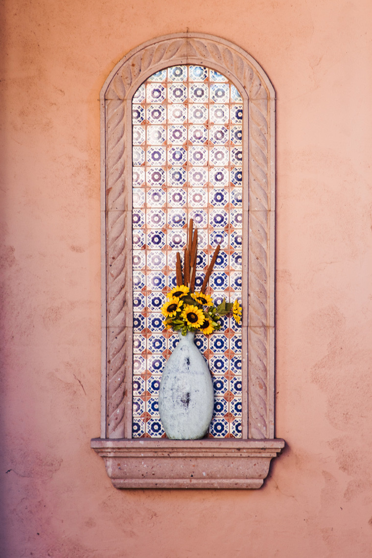 Artistic tile detail and vase of sunflowers in the Hilton Sedona Resort at Bell Rock spa, showcasing the spa's calming decor