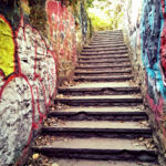 Stone steps leading through the Glendinning Rock Garden in Fairmount Park, Philadelphia, highlighting pedestrian access in the park's revitalization plan.