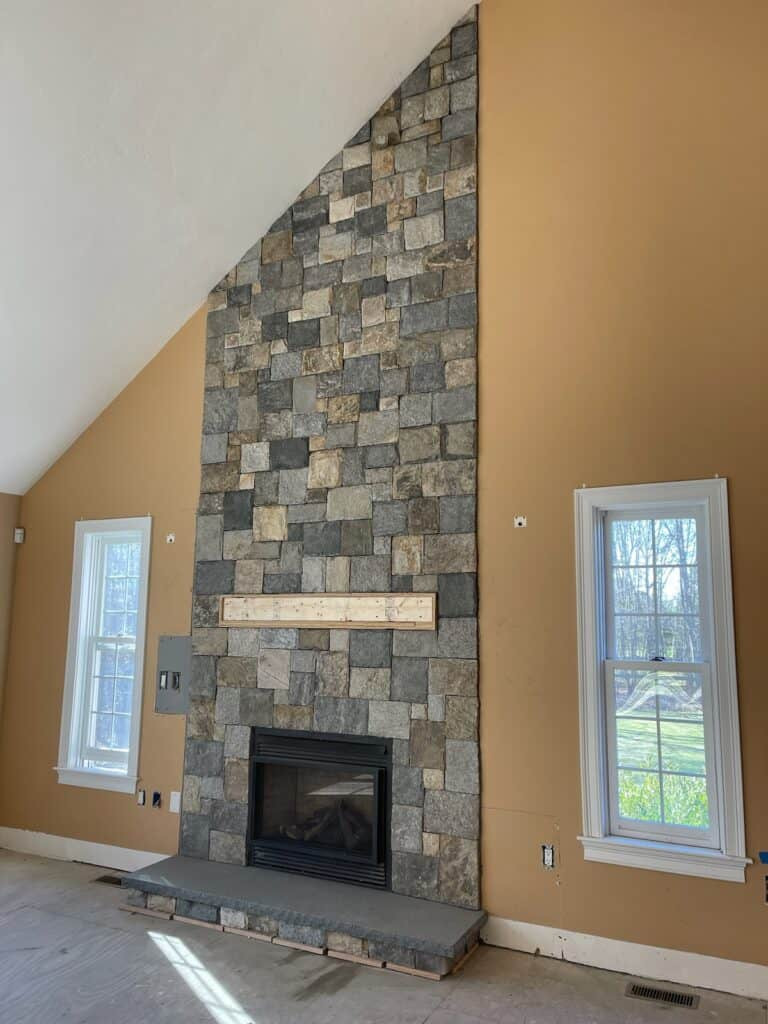 Boston Blend Square &amp; Rec stone fireplace with an irregular pattern and asymmetrical ceiling