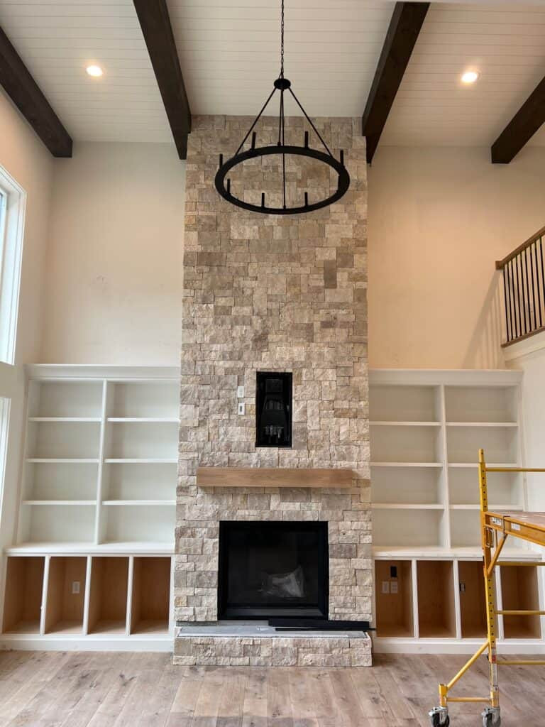 Cottage Standard Cut stone fireplace in a modern black and white interior setting