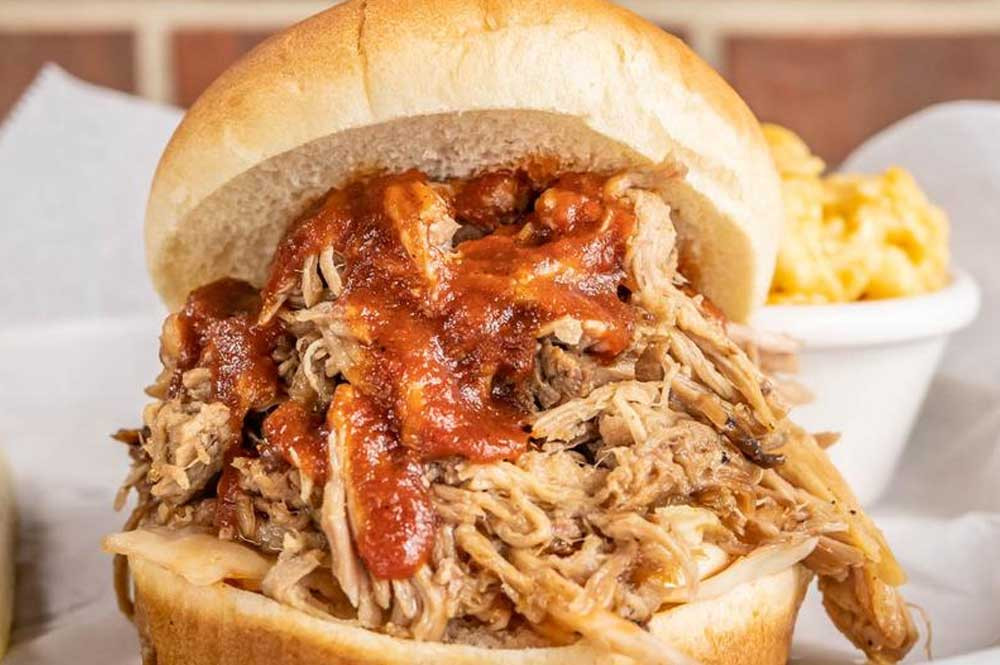 Pulled Pork BBQ Sandwich at The Dixie Pig Restaurant, a must-try item at this Rock Hill BBQ joint