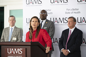 Arkansas Governor Sarah Huckabee Sanders speaks at the UAMS Orthopaedic &amp; Spine Hospital inauguration, with Chancellor Cam Patterson, Little Rock Mayor Frank Scott, and Dr. Lowry Barnes listening.