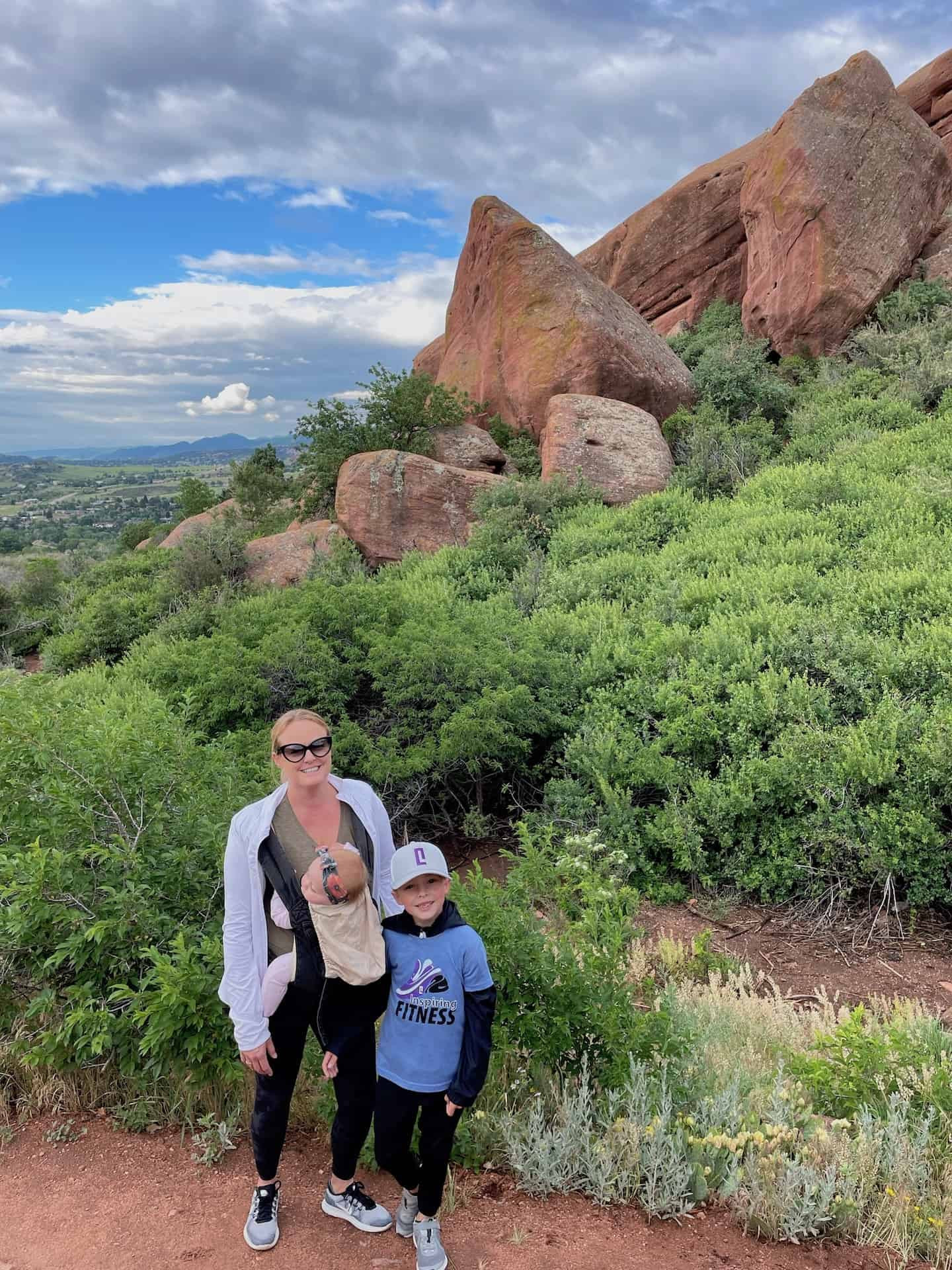 A family hiking on the Trading Post Trail at Red Rocks Park Denver