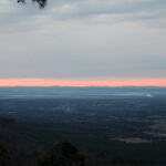 Sunrise casting warm light over the Arkansas landscape from Mount Nebo State Park