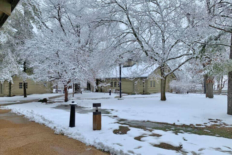 Winter scene of a snow-covered cabin at Starved Rock Lodge