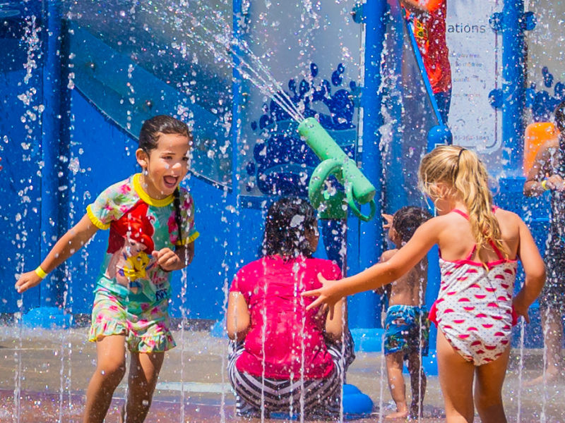 Kids having fun on a sunny day at White Rock Splash Park, a popular summer attraction in Northern California.