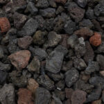 Black lava rock used in a garden bed