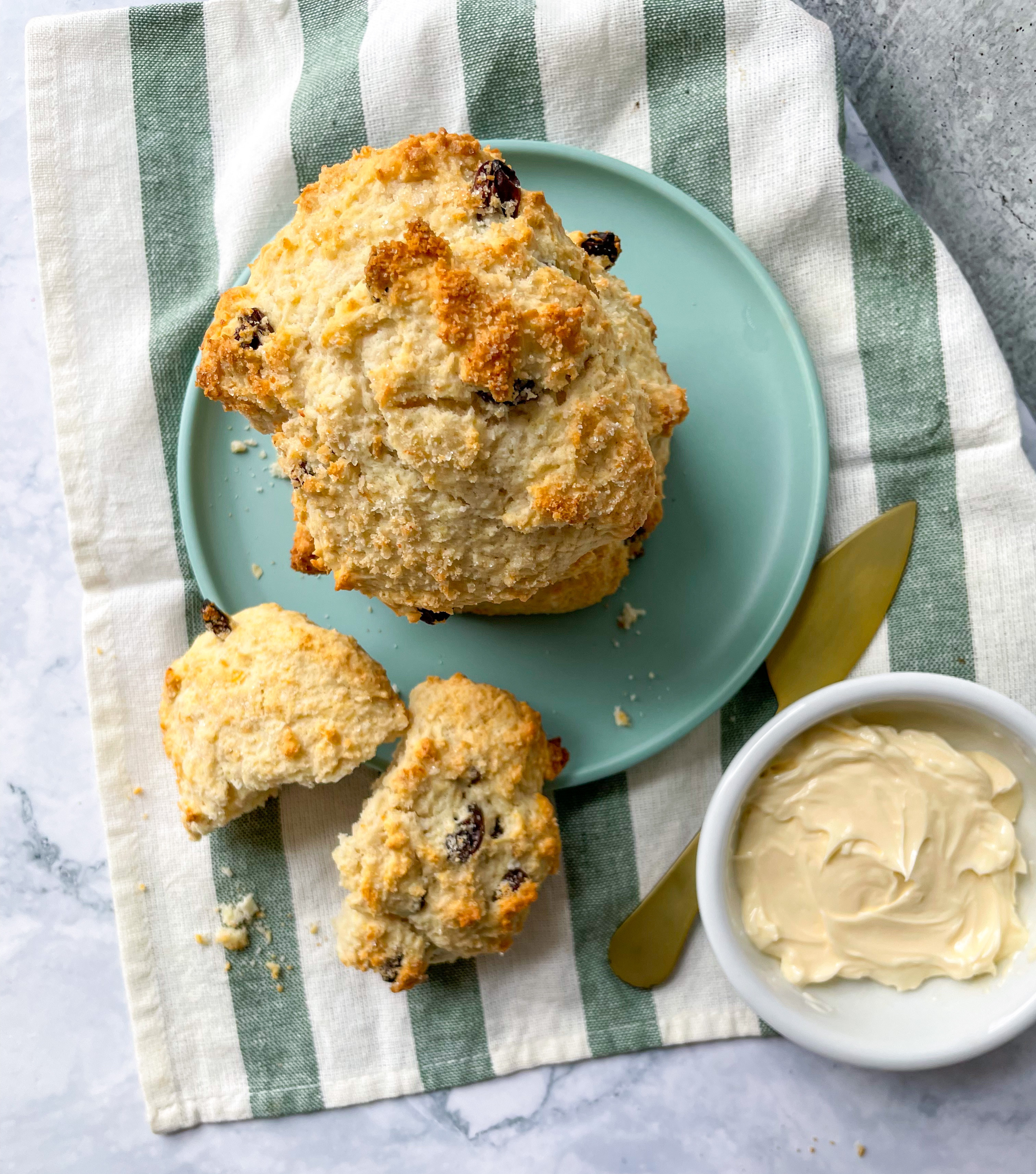 A batch of golden Jamaican rock cakes on a cooling rack, showcasing their rustic texture and appealing appearance.
