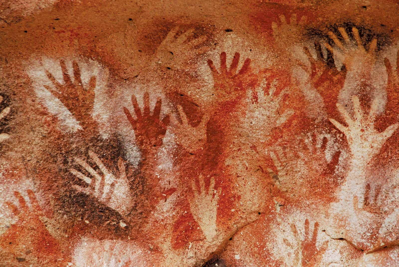 Cave paintings featuring handprints in Cueva de las Manos, Argentina, a testament to early artistic expression and cultural significance.