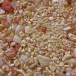 Carbonate sand with abundant fragments of corals, echinoids, molluscs, and pink foraminifera. Deposits of carbonate sand transform into carbonate rocks during burial and diagenesis. Field of view: 32 mm. Photo © Siim Sepp.