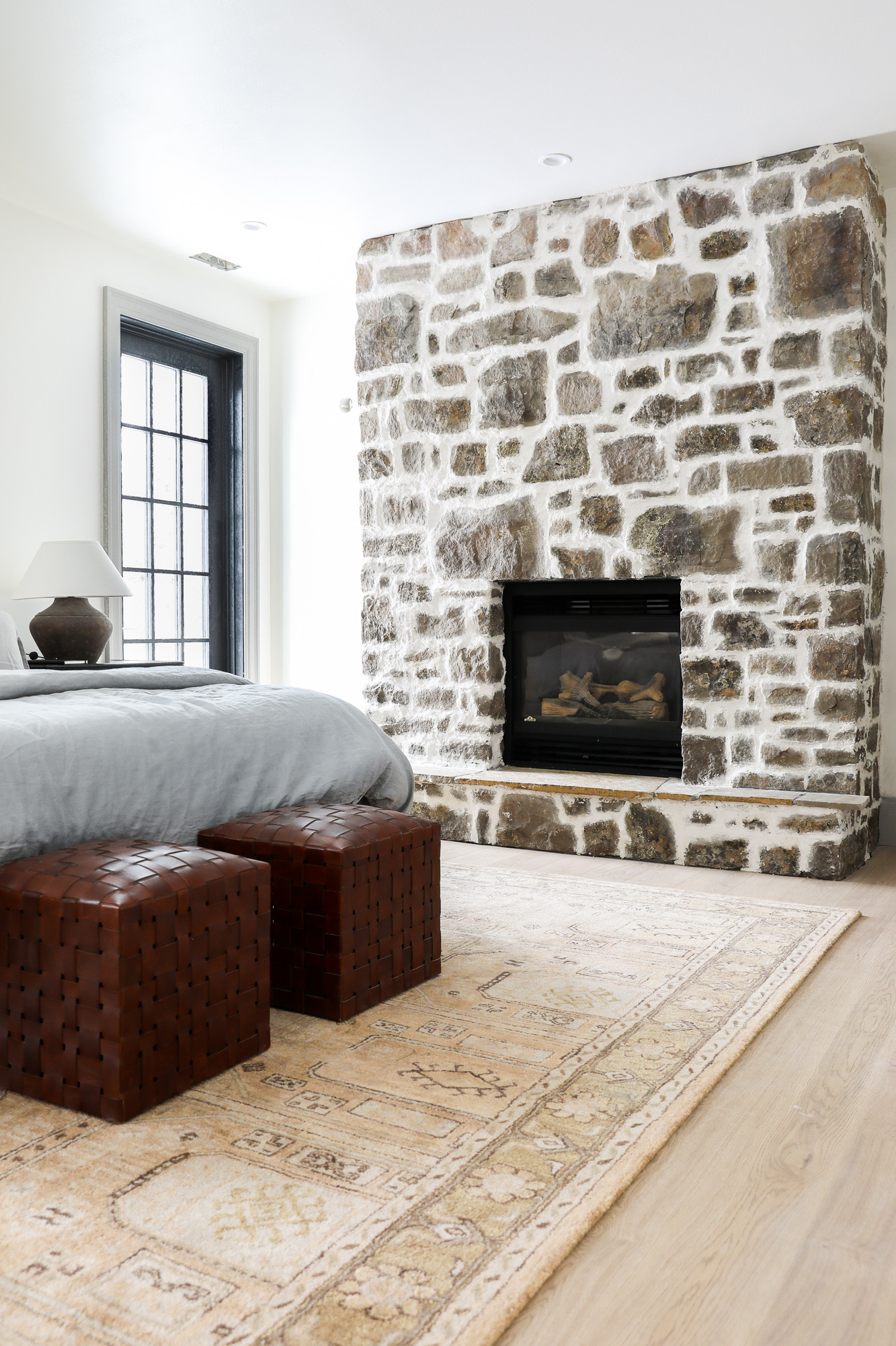 A rock fireplace wall with a wood mantle