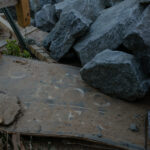 fallen sign for Chimney Rock under rocks