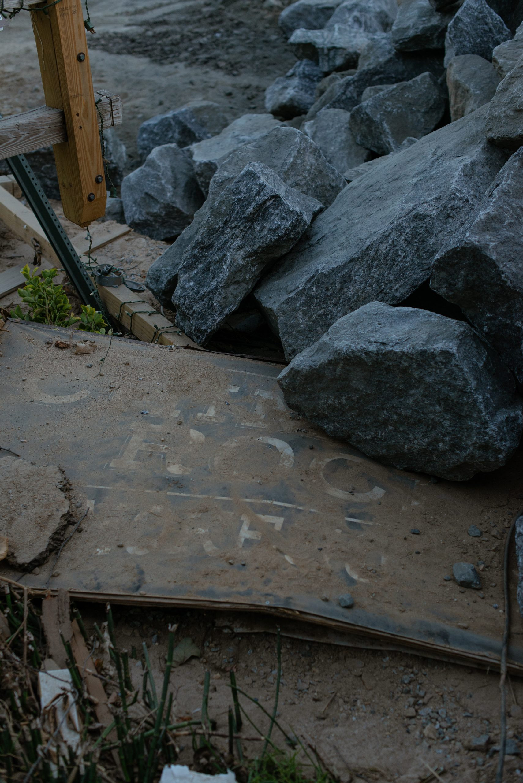 fallen sign for Chimney Rock under rocks