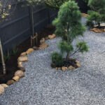Graphite Grey Slate Rockery stones provide a gentle contrast against the brighter, lighter colored gravels in this tranquil Zen rock garden