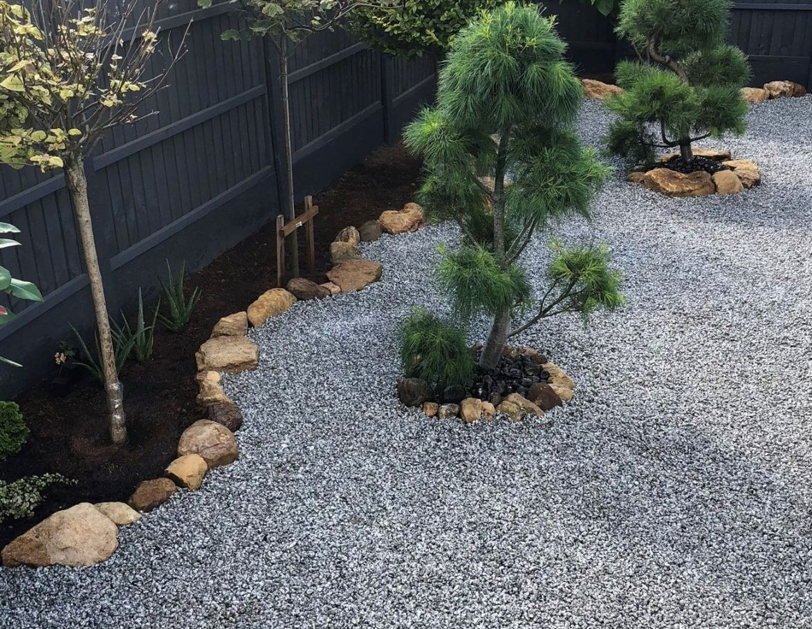 Graphite Grey Slate Rockery stones provide a gentle contrast against the brighter, lighter colored gravels in this tranquil Zen rock garden