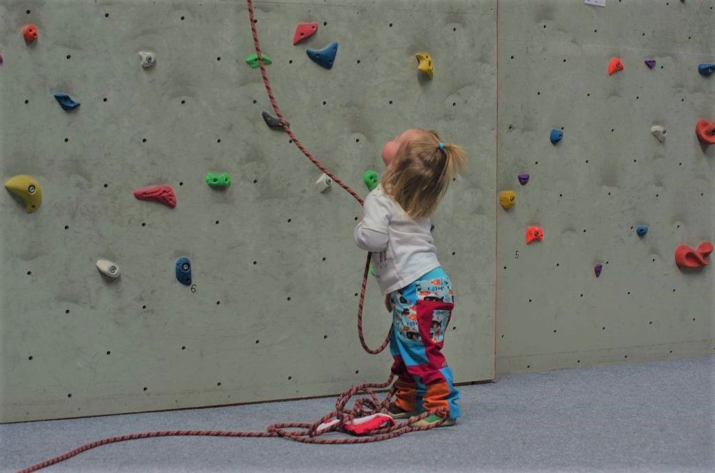 Kids are learning how to use ropes for the safe rock climbing