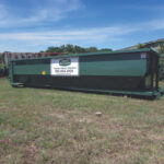 Roll-off dumpster filled with rocks for disposal