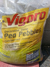 Close-up of pea gravel showing debris accumulation