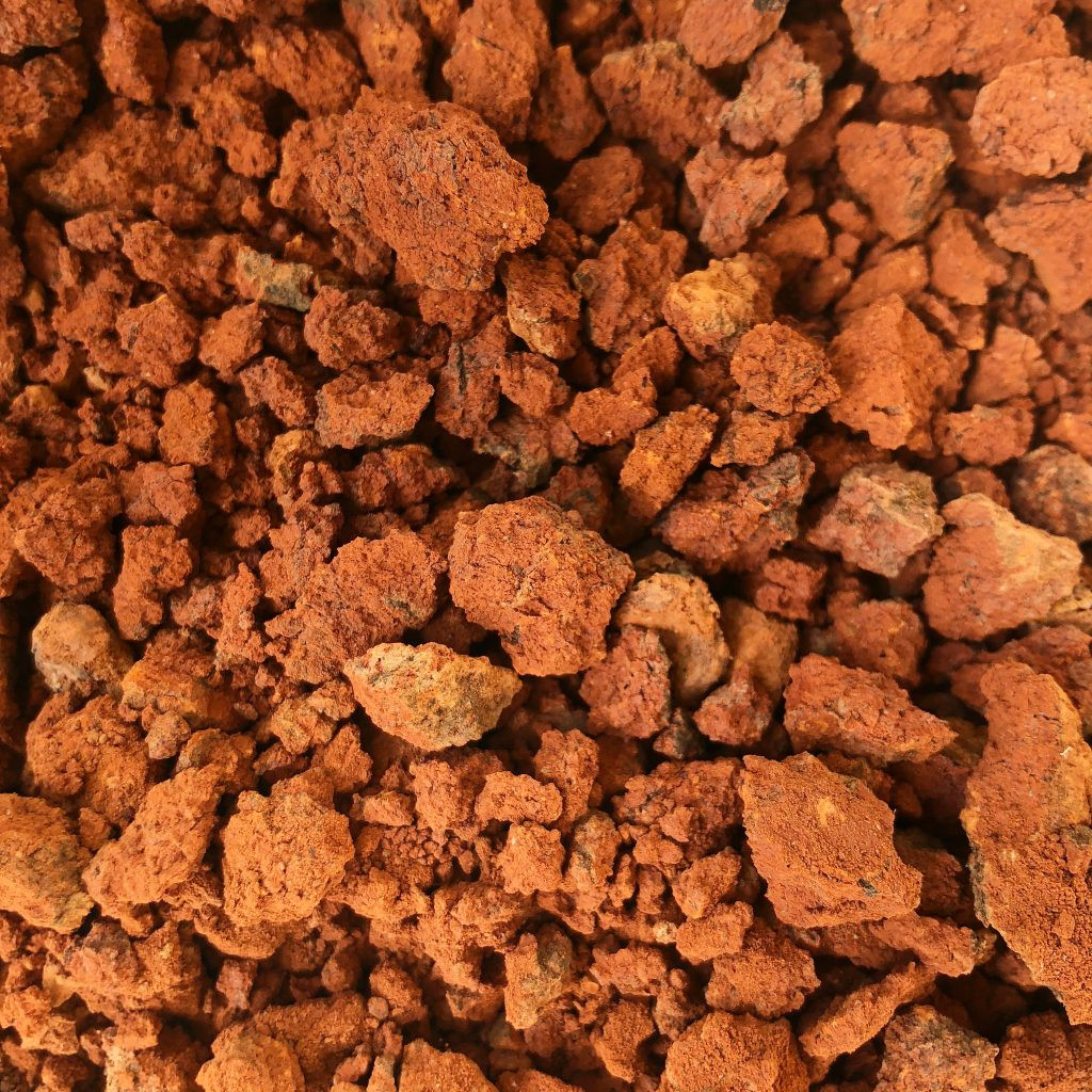 Rock-breaking tools including sledgehammer, rock chisels, safety glasses, and gloves, essential for safe and effective rock splitting in landscaping projects