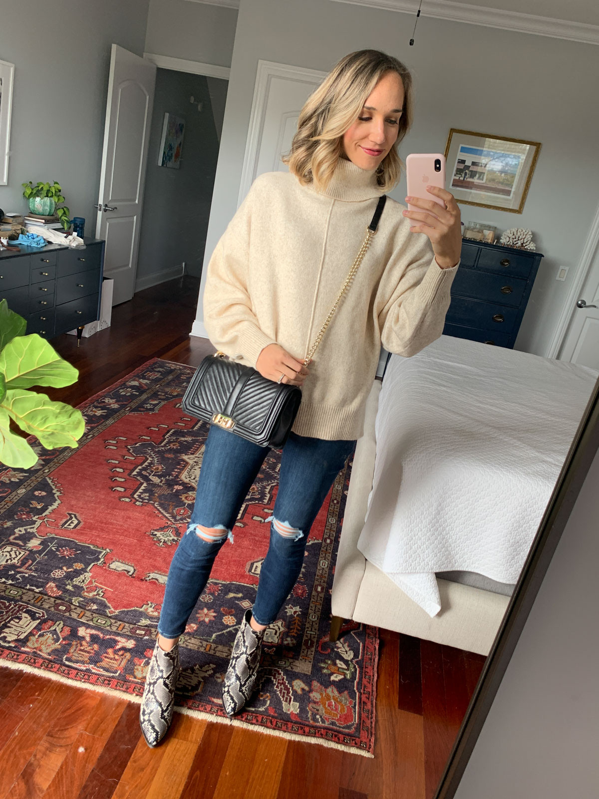 Woman wearing an oversized turtleneck sweater with skinny jeans, creating a balanced silhouette