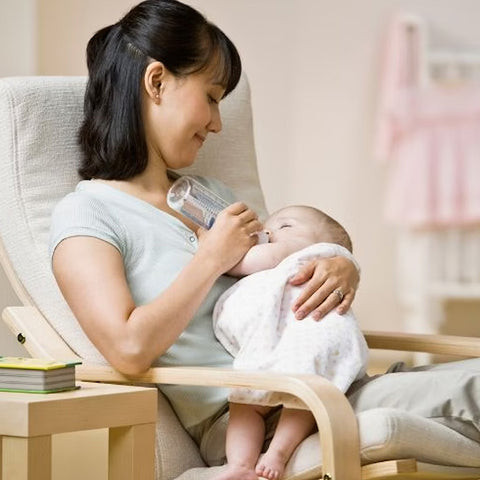Modern gray rocking chair with ergonomic design and cushioned support, ideal for pregnant women