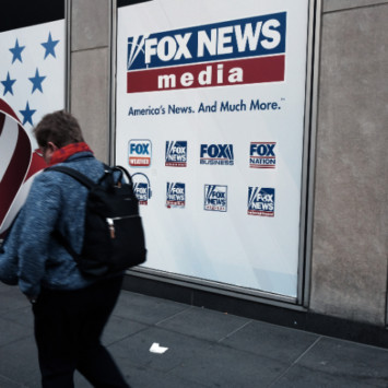 People walk by the News Corporation headquarters, home to Fox News, on April 18 in New York City