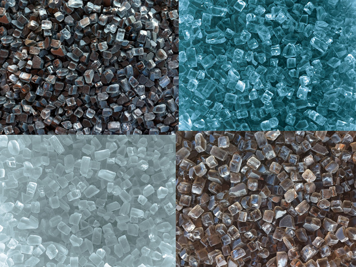 Close up of a hand holding fire glass pebbles