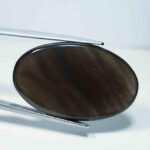 Black obsidian cabochon with a smooth, polished surface