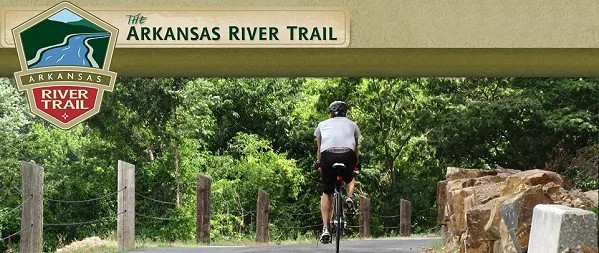 A scenic view of the Arkansas River Trail with stone features along the riverbank
