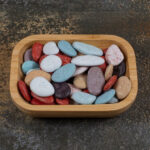 Assorted rocks and minerals displayed in a decorative glass bowl