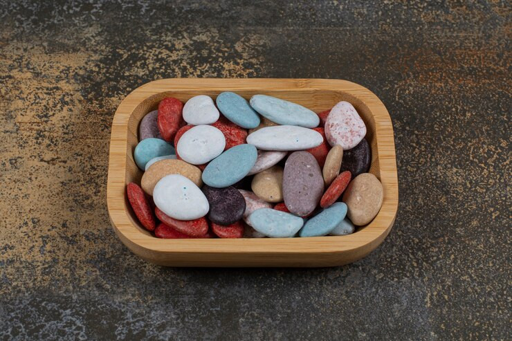 Assorted rocks and minerals displayed in a decorative glass bowl