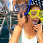 Snorkeling at Black Rock Beach, Maui, with clear blue water and colorful fish visible.