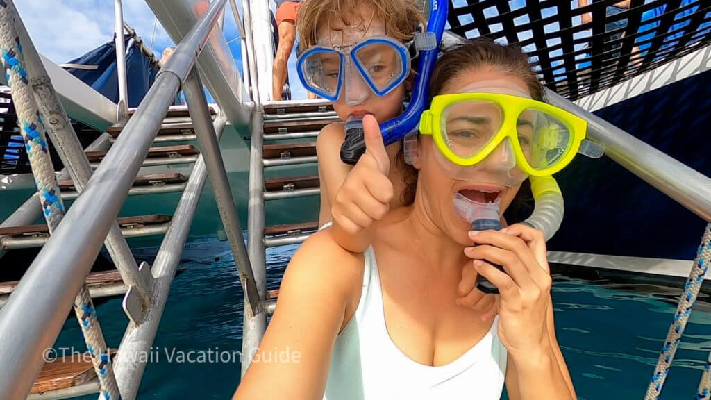 Snorkeling at Black Rock Beach, Maui, with clear blue water and colorful fish visible.