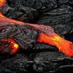 Lava rocks near the ocean in Hawaii with Pele's curse attributed to removing them