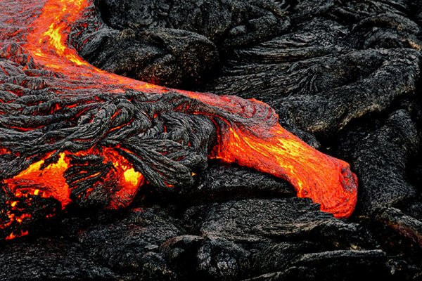 Lava rocks near the ocean in Hawaii with Pele's curse attributed to removing them
