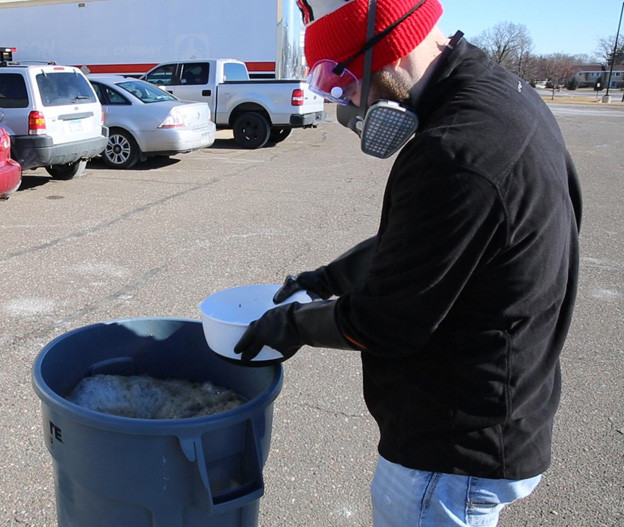 Wearing protective gear during a bleach cure of live rock