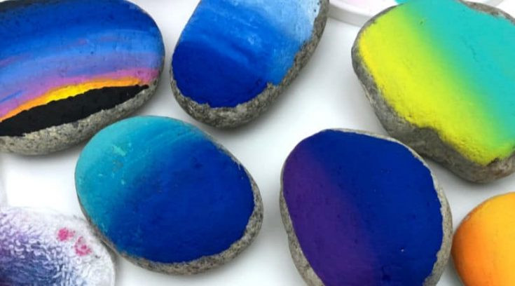 Blending paints on rocks, creating smooth transitions and colorful effects
