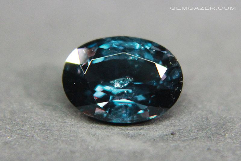 Blue Garnet gemstone displaying its unique color-changing properties under different lighting conditions.